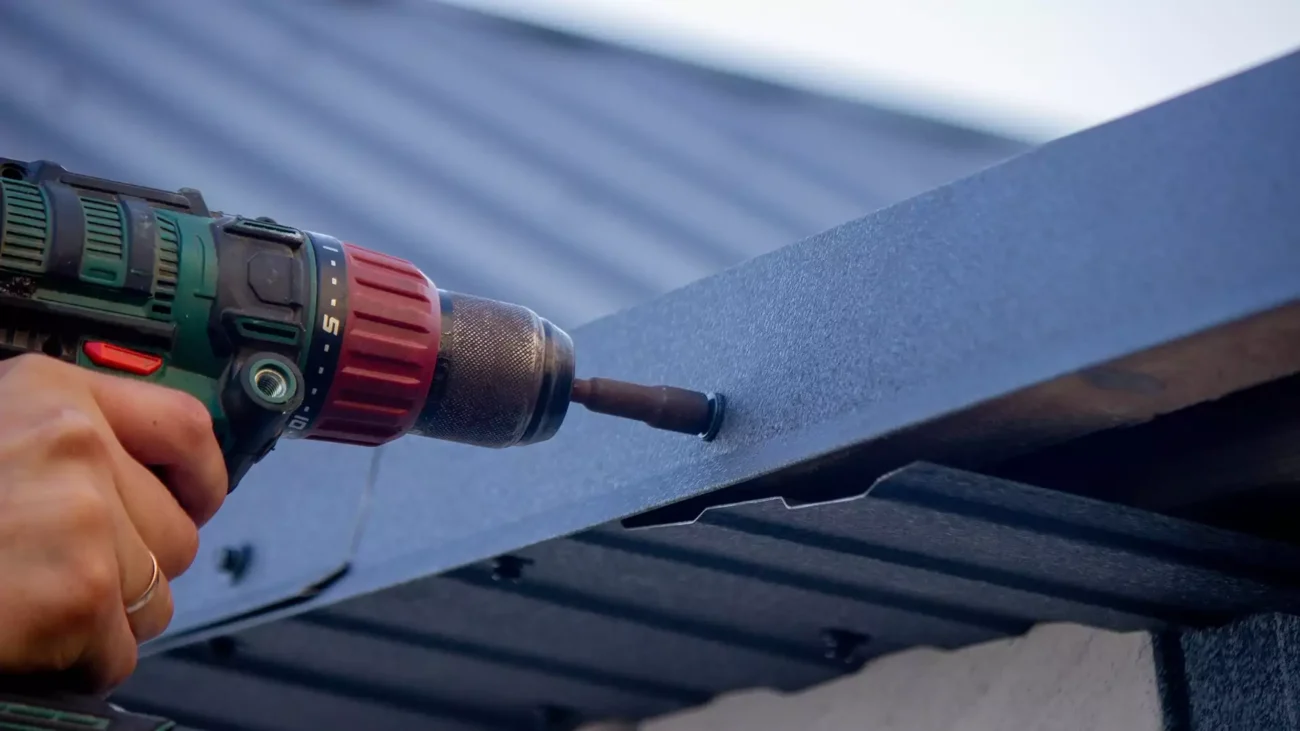 man repairs roof
